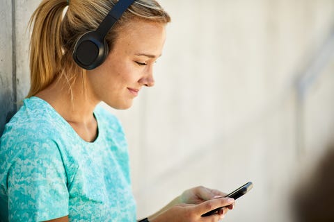 Close up view of a young Argentinian women using a mobile music app. close up view of a young argentinian women using a mobile music app