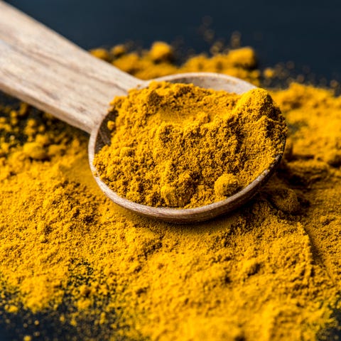 Closeup of tumeric powder spice on a spoon Closeup of tumeric powder spice on a spoon