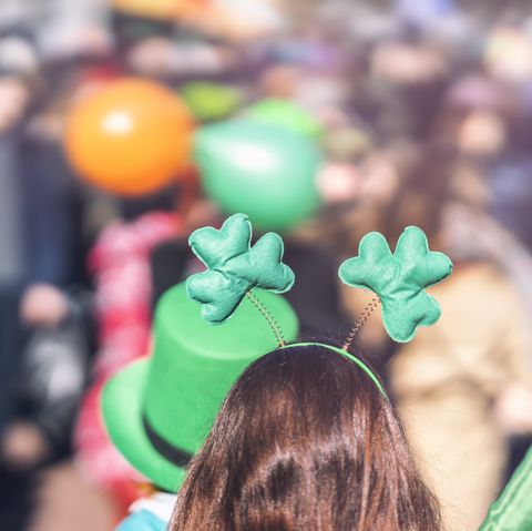 clover head decoration on head of girl close up saint patrick day, parade in the city, selectriv focus