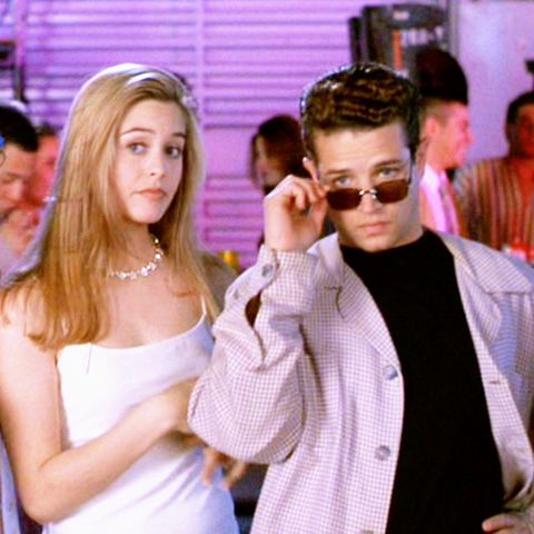 a scene from clueless where cher horowitz is wearing a white dress and a white choker