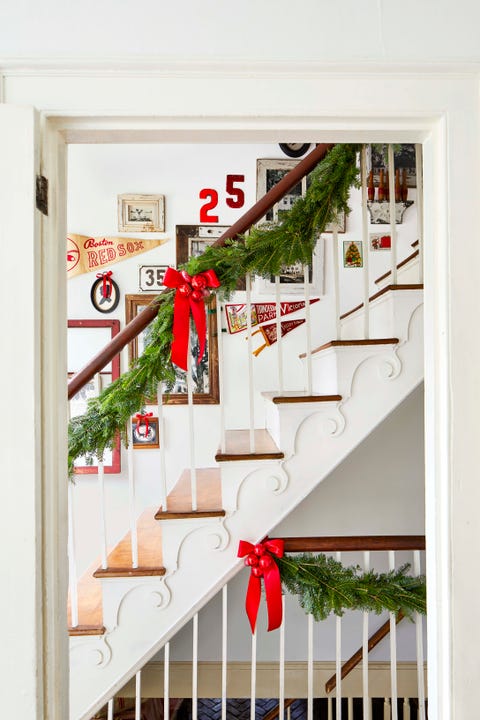 christmas garland with red bows on a staircase