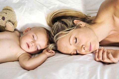 Portrait of a baby and a mother sleeping, indoors