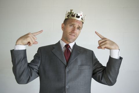 Cocky Businessman Pointing to Golden Crown Like He's the King