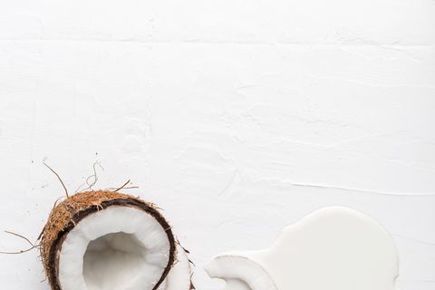 Coconut, egg and fresh milk on a white background, top view