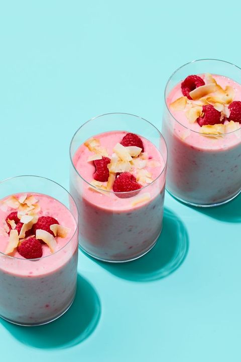 three glasses of creamy, pink coconut raspberry smoothie, a healthy sweet snack