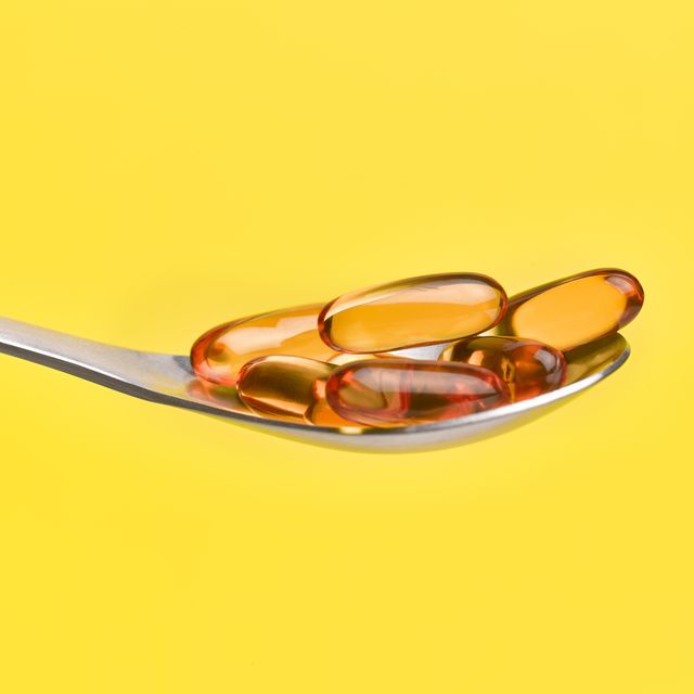 cod liver oil capsules on spoon