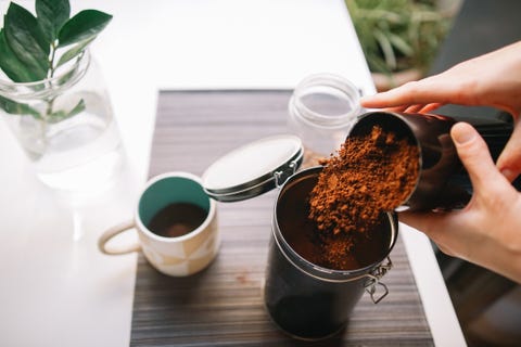 coffee grounds garden   cropped hands pouring ground coffee into reusable container