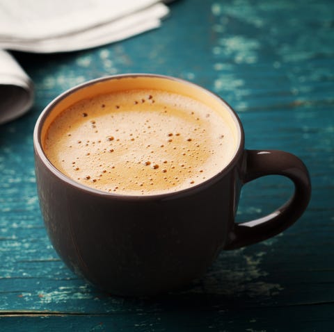 Coffee mug with newspaper on teal rustic table, cozy breakfast