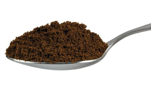 ground coffee on a spoon
