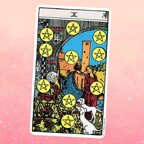 the tarot card the ten of coins, showing two young people talking, while an old, bearded man and two white dogs sit in front of them ten coins with pentacles on them are scattered across the scene
