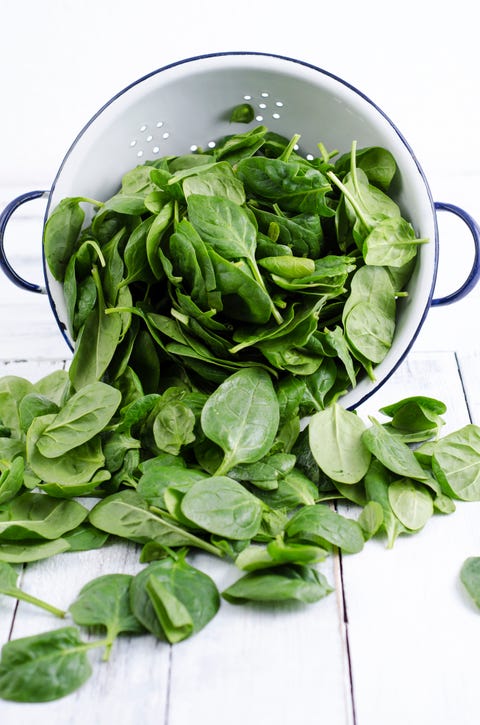 Colander and fresh spinach leaves Colander and fresh spinach leaves