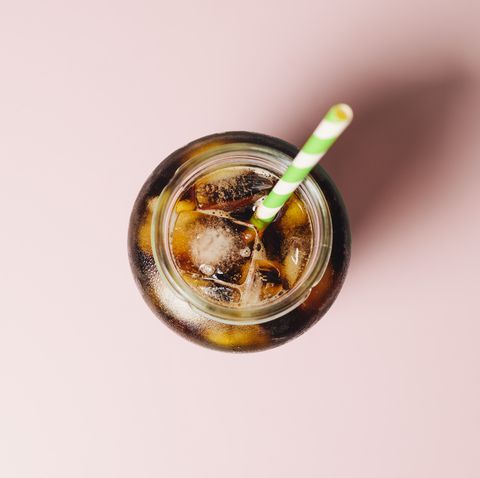 Cold brew coffee against a pink background.