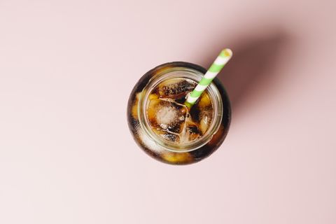 Cold brew coffee against a pink background.