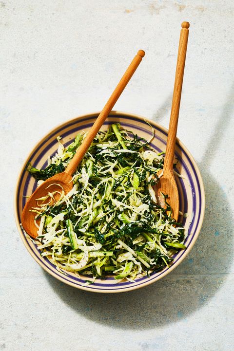a bowl of green coleslaw with shredded cabbage, kale, jicama and cucumbers