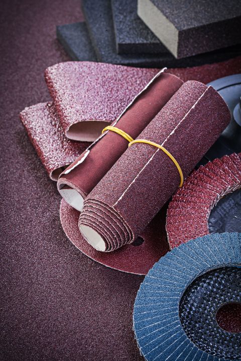collection of abrasive tools on sandpaper top view
