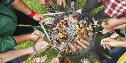 A collection of friends gathered around a bbq