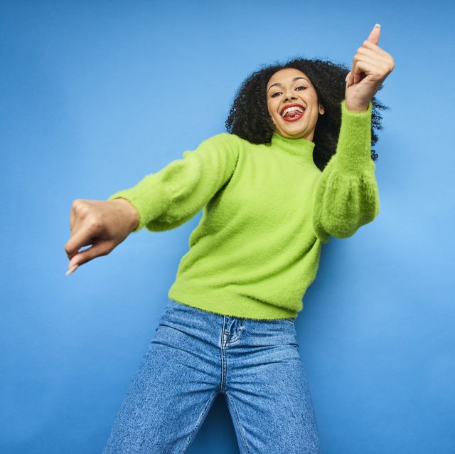 colourful studio portrait of a young woman dancing