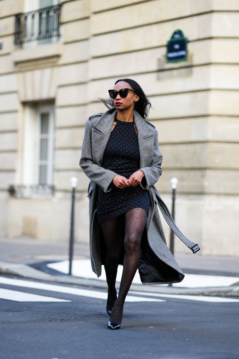 paris, france   january 11 emilie joseph infashionwetrust wears a gray oversized belted wool herringbone coat from frankieshop, a black polka dots print mini dress, polka dots tights from calzedonia, black patent leather pointy pumps shoes, during a street style fashion photo session, on january 11, 2022 in paris, france photo by edward berthelotgetty images