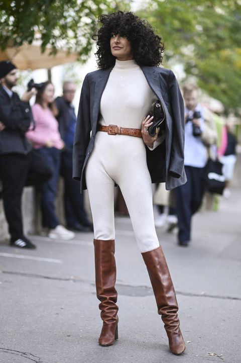paris, france   september 28 a guest is seen wearing a white one piece, gray blazer, brown belt and brown boots outside the acne show during paris fashion week ss 2023 on september 28, 2022 in paris, france photo by daniel zuchnikgetty images