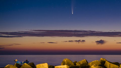 comet neowise shining above the port of molfetta
