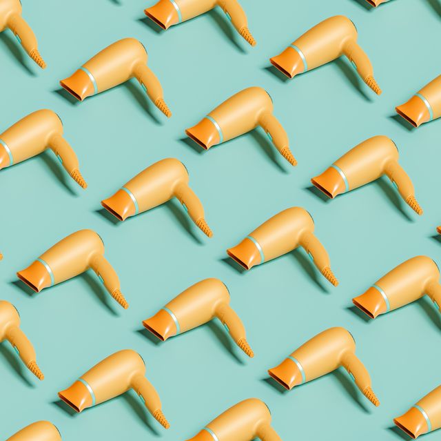 computer generated image of  many orange hair dryers on green isolated background, 3d render
