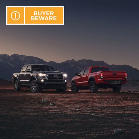 two pick up trucks in a desert and mountain setting