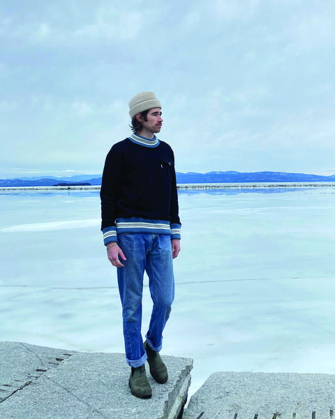 man standing by a frozen lake