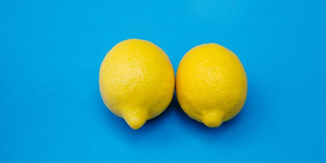 conceptual image for breasts, nipples, woman's issues, health and wellness, symmetry, sexual issues, lemons on blue background