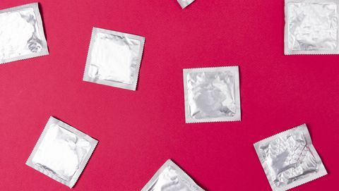 Condoms on pink background. concept of contraception and safe sex. Protection from HIV during sexual intercourse.