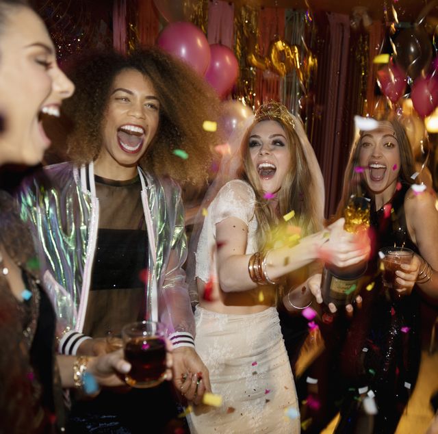 confetti falling over laughing bachelorette and friends in nightclub