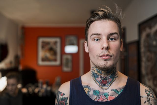 confident tattooed man at studio