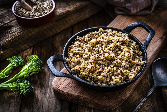 cooked quinoa in a cast iron pan on rustic wooden table