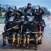US-POLICE-CRIME-UNREST-RACISM minneapolis police officers in riot gear leave as protesters gather after an officer shot and killed a black man in brooklyn center, minneapolis, minnesota on april 11, 2021 protests broke out april 11, 2021 night after us police fatally shot a young black man in a suburb of minneapolis where a former police officer is currently on trial for the murder of george floyd hundreds of people gathered outside the police station in brooklyn center, northwest of minneapolis police fired teargas and flash bangs at the demonstrators, according to an afp videojournalist at the scene photo by kerem yucel afp photo by kerem yucelafp via getty images