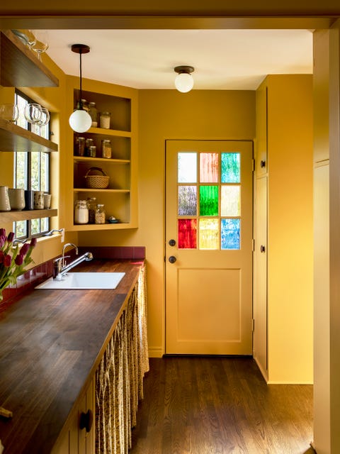 yellow kitchen with stained glass window