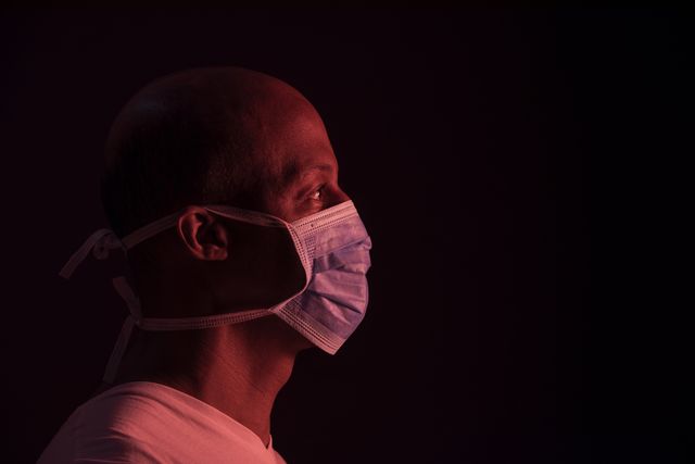 coronavirus, side portrait of african american man with protective mask