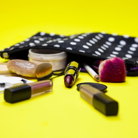 cosmetics and make up equipment on yellow background