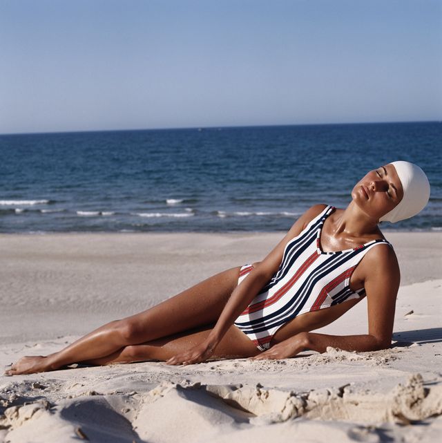 a model wearing a striped cutaway swimsuit reclines on the beach, circa 1973 photo by archive photosgetty images