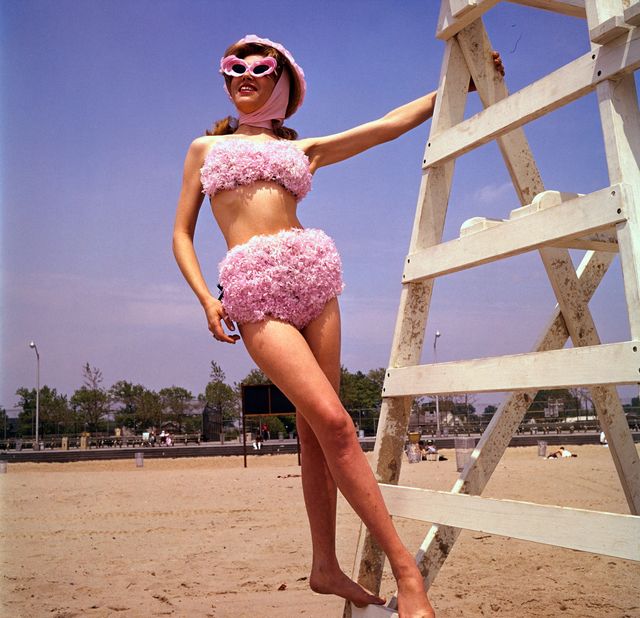 original caption new york body garden the flower of adventurous womanhood blossoms out in this garden variety bikini sunsuit by flower mode of new york worn by barbara nelson, the brief suit is completely covered  except where the wearer sits down  with artificial pink hyacinth petals photo by bettmann via getty images