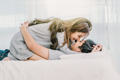 Couple and life style concept, Closeup Happy Asian Lover kissing and hugging on the bed in bedroom at modern home