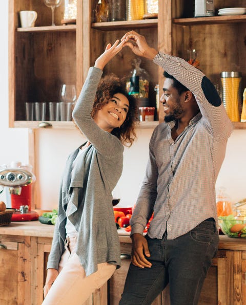 falling in love couple dancing at kitchen, looking at each other, panorama, copy space