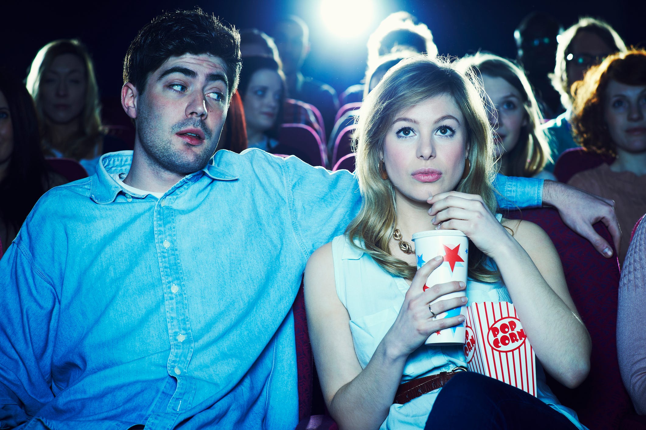 couple enjoying a movie at the cinema