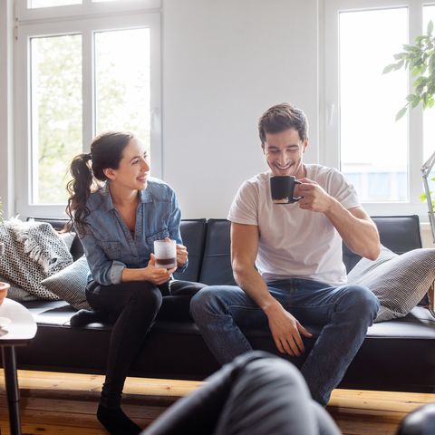 couple having coffee together in living room