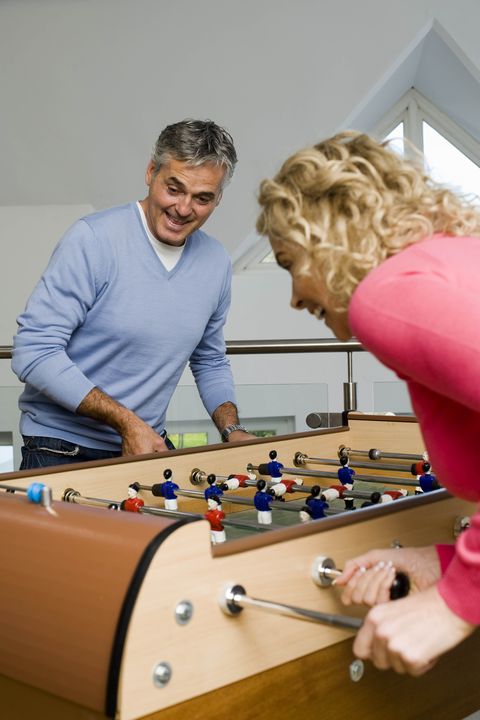 couple having fun playing table football