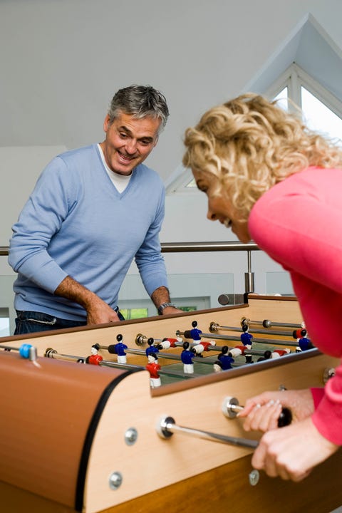 couple having fun playing table football