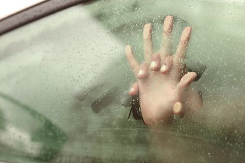 Couple holding hands having sex inside a car