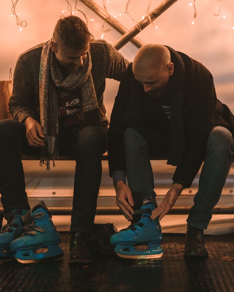couple lacing up ice skates