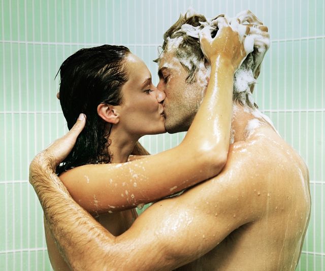 couple kissing in shower, woman shampooing man's hair