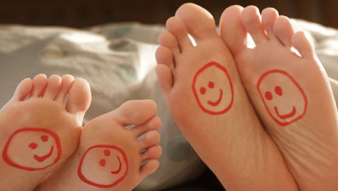 couples happy feet in bed