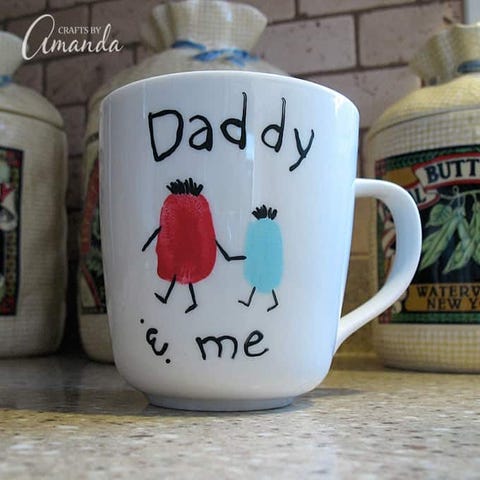 white mug with thumbprint figures and daddy and me written on it