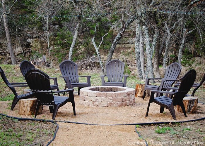 black adirondack chairs around fire pit